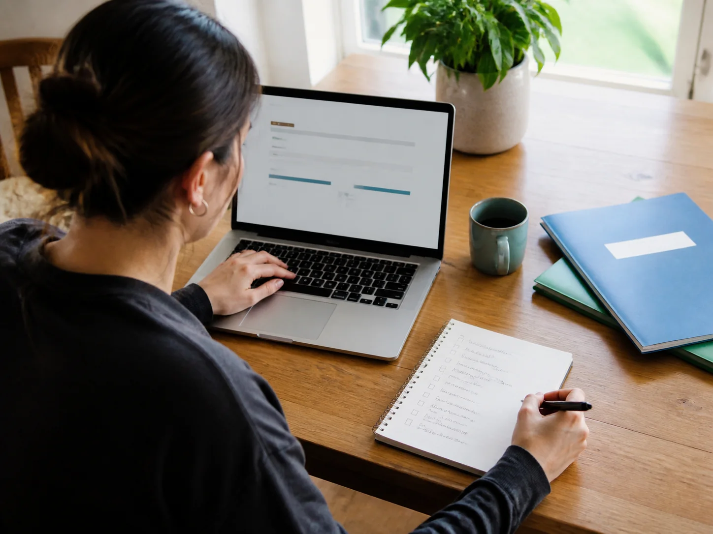 A borrower reviewing repayment options and organizing next steps at a home workspace.